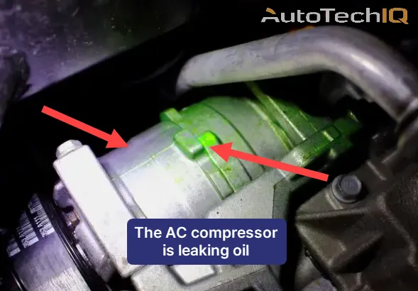 Refrigerant fluid leak signs on an AC compressor