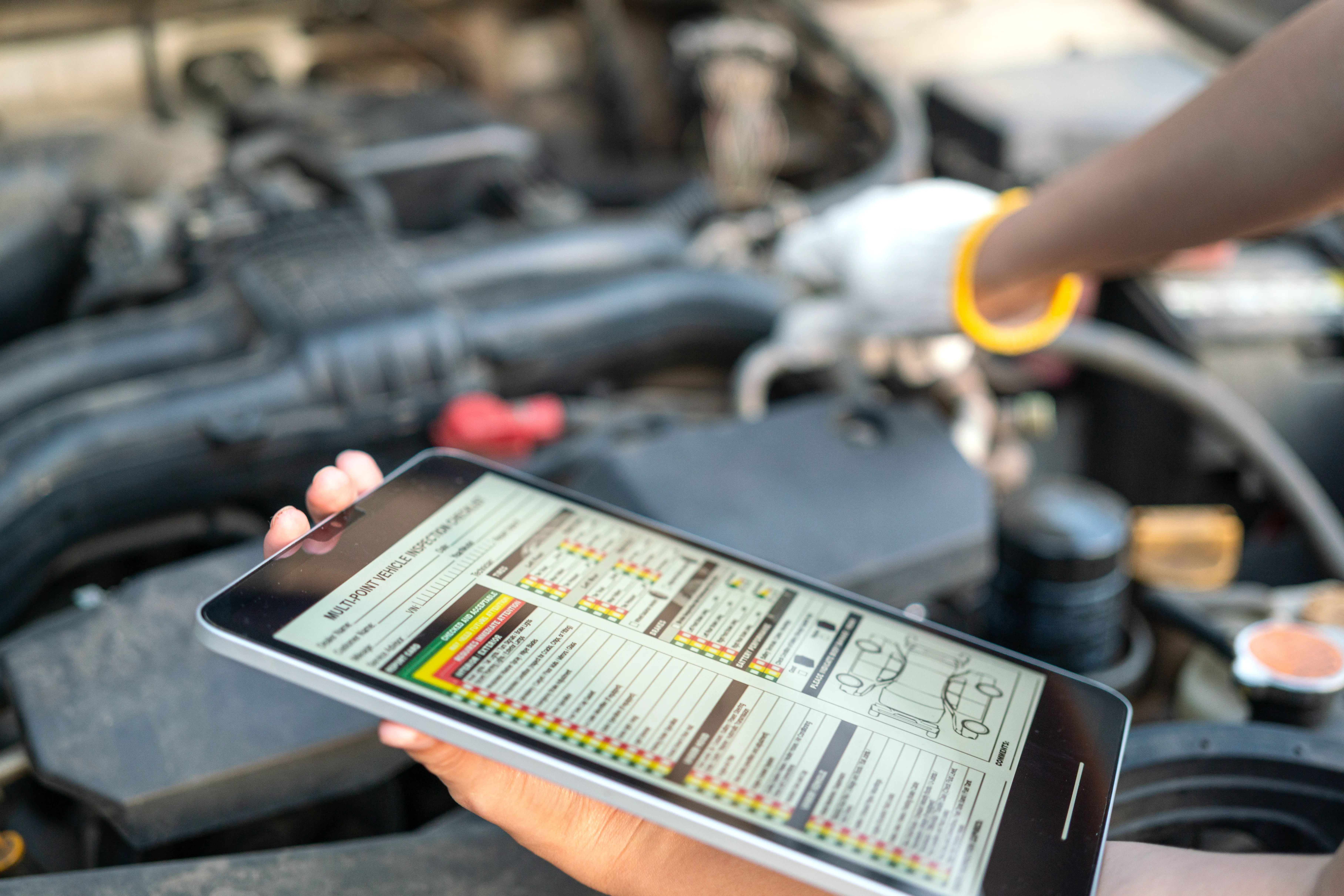 Preventative maintenance on a vehicle. The mechanic is scanning the car for trouble codes